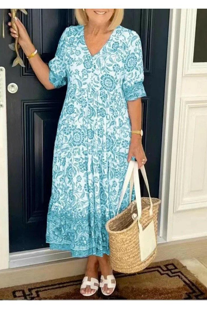 Blue Lumina Wear ARIA floral dress with V-neck, featuring elegant design and fitted silhouette, perfect for summer occasions.