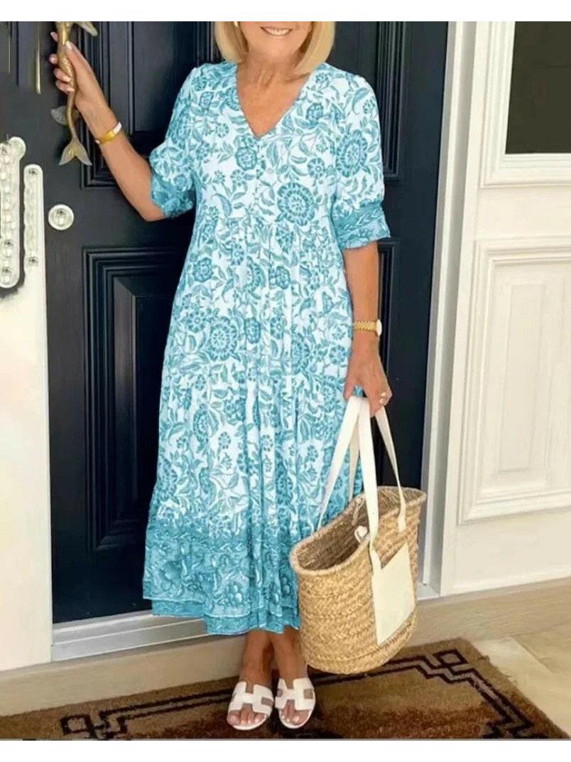Blue ARIA™ floral dress with V-neck by Lumina Vancouver, featuring elegant design and fitted waist for sophisticated style.
