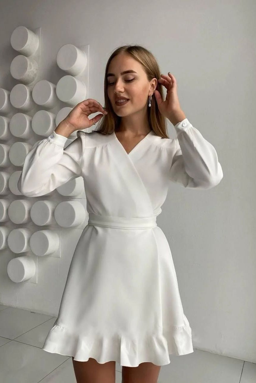 White Aria long sleeve mini dress with fitted bodice from Lumina Vancouver, showcasing a stylish, elegant design.