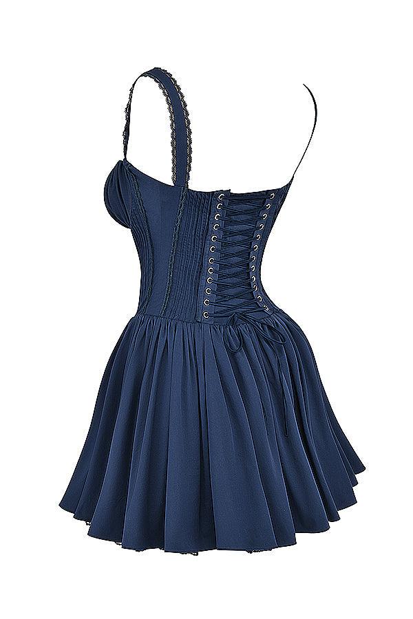 White mini dress by Lumina Vancouver featuring a lace-trimmed bodice and short sleeves, displayed on a hanger.