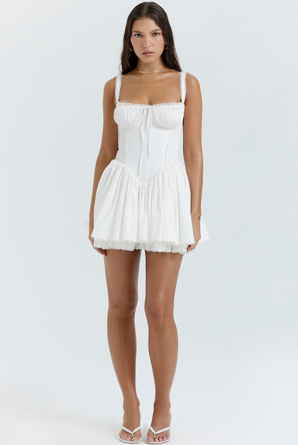 White mini dress with lace-trim bodice from Lumina Wear, featuring a fitted silhouette and delicate lace detailing.