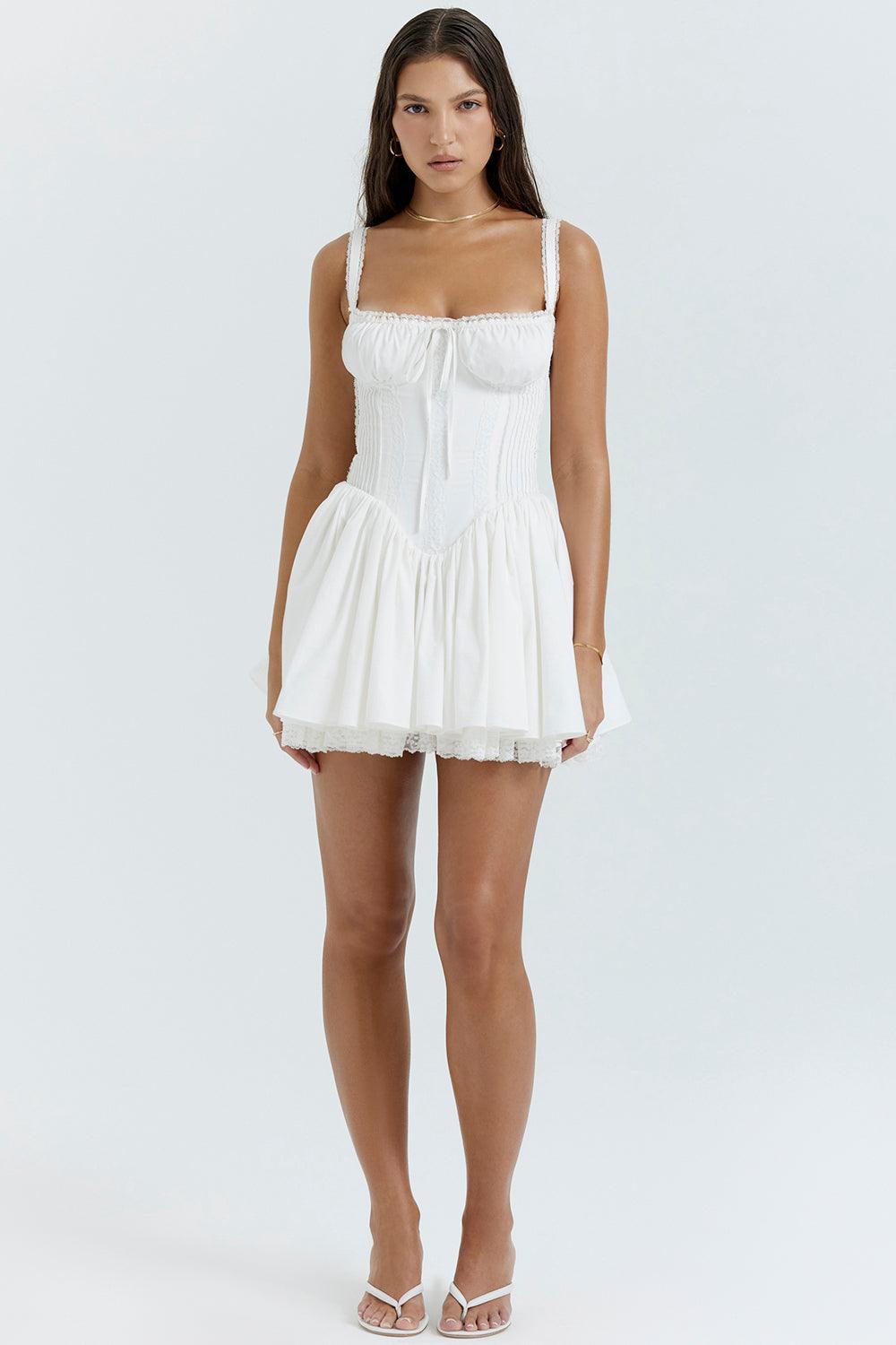 White mini dress by Lumina Vancouver with lace trim on the bodice and a fitted silhouette.