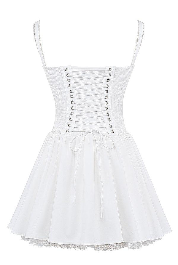 White mini dress by Lumina Wear with lace-trim bodice, featuring a fitted silhouette and delicate detailing.