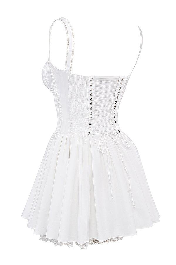White mini dress by Lumina Vancouver with lace-trimmed bodice, featuring a fitted silhouette and delicate detailing.