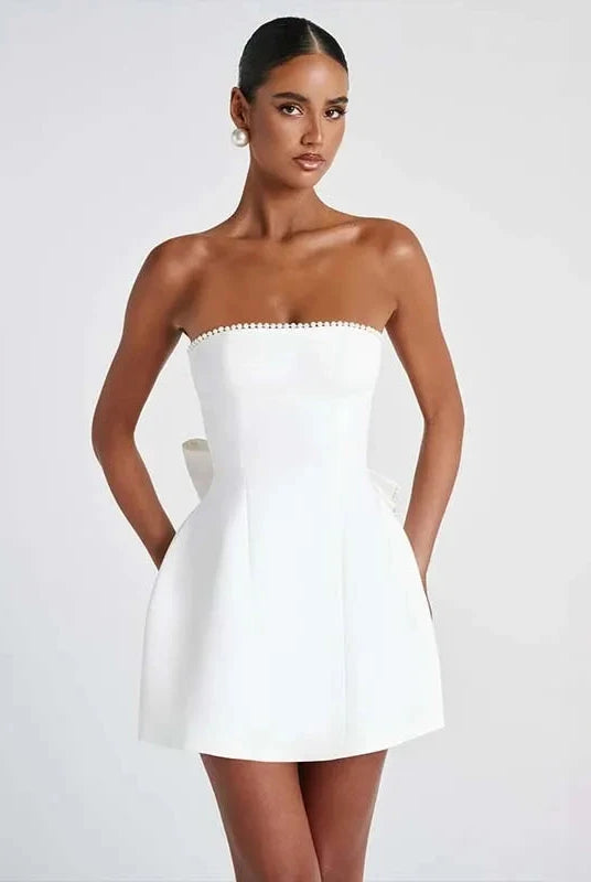 White strapless satin mini dress by Lumina Wear, featuring a fitted silhouette and elegant design for stylish occasions.