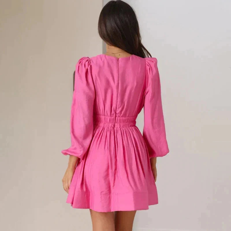 Black Aria mini dress with deep V-neck from Lumina Vancouver, featuring a fitted silhouette and stylish design.
