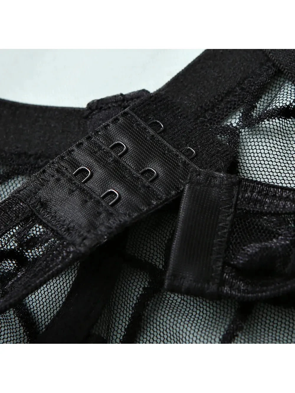 Lumina Vancouver Tellervo Bodysuit in black, close-up of fitted, sleek design with scoop neckline and long sleeves.