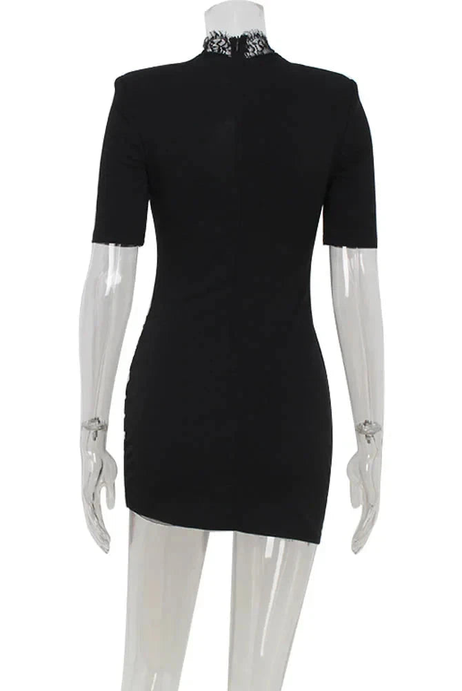 Black Lumina Wear Nanna mini dress with a bodycon fit, shown on a model, highlighting its sleek and fitted silhouette.