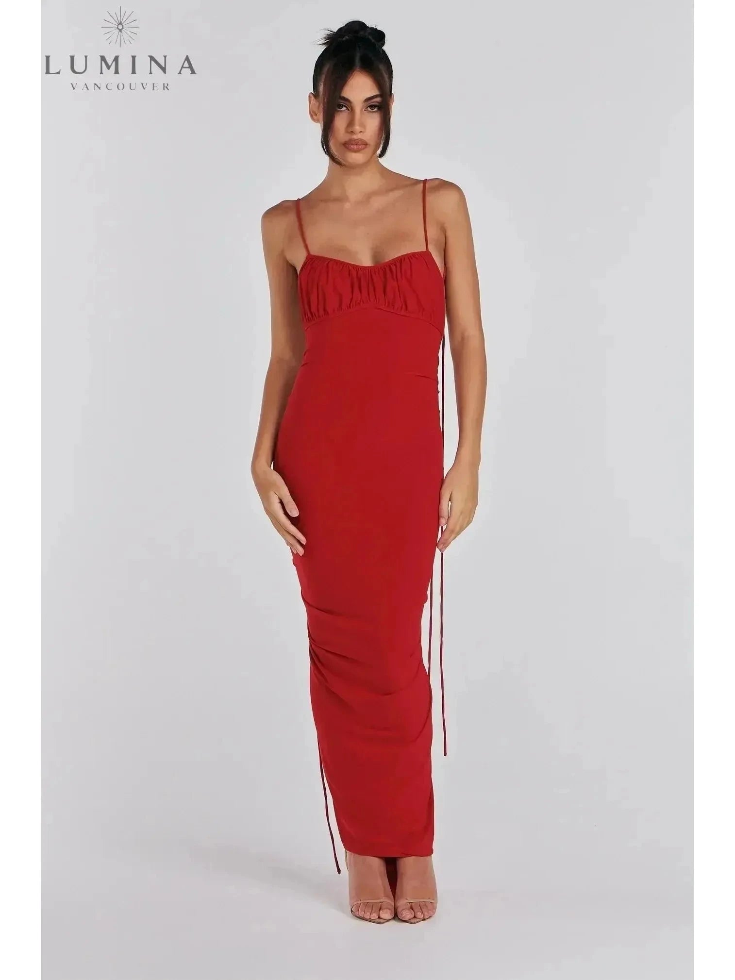 Red Astrid backless maxi dress by Lumina Vancouver, elegant wedding guest gown with flowing fabric and sleeveless design.
