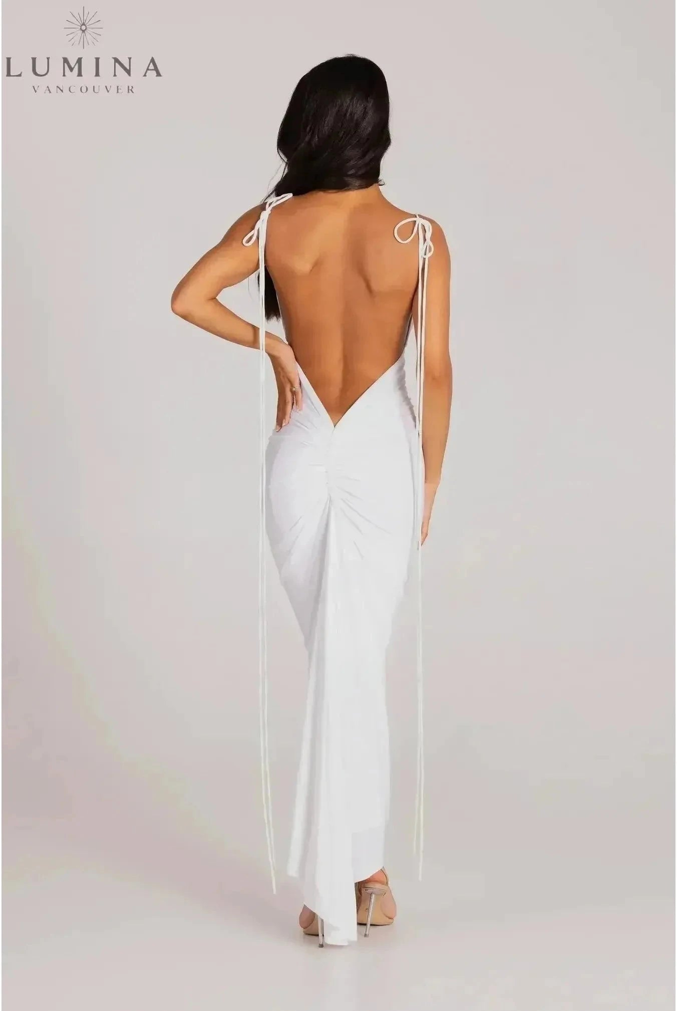 Red Astrid backless maxi dress by Lumina Wear, elegant wedding guest gown with flowing fabric and sleeveless design.