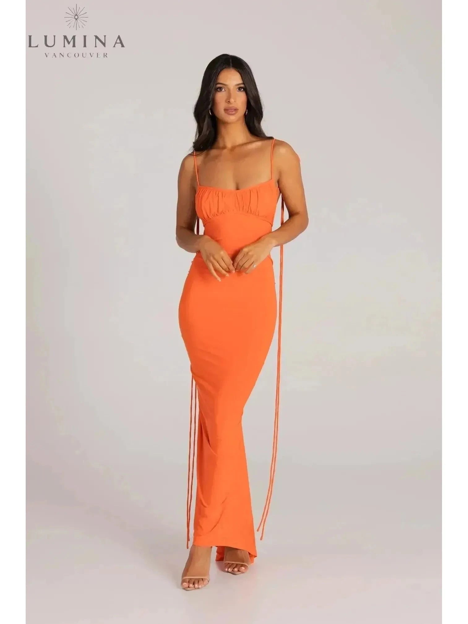 Red Astrid backless maxi dress by Lumina Vancouver, elegant wedding guest gown with flowing fabric and stylish open back.