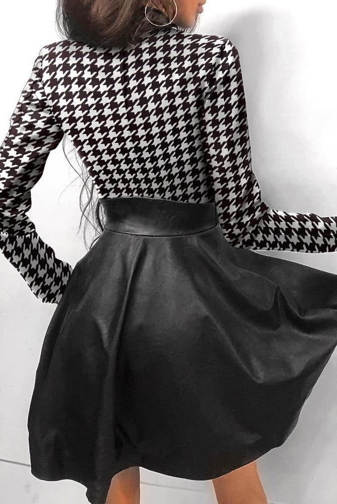 Black Astrid faux leather mini dress by Lumina Wear, form-fitting with long sleeves and a stylish mini length.