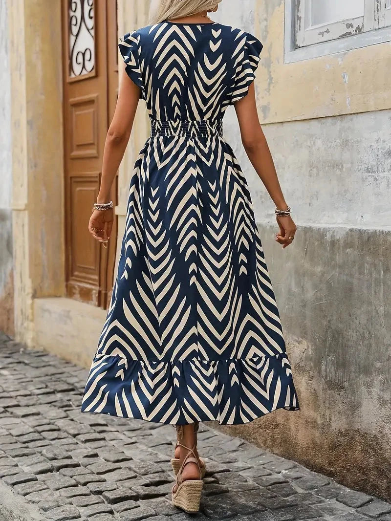 Blue Aurelia sleeveless V-neck mini dress by Lumina Vancouver, showcasing a fitted silhouette and stylish design.