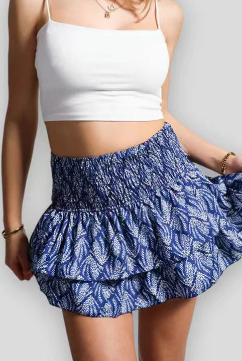 A women's bohemian ruffle skirt with vibrant pink print from Lumina Wear, featuring playful layered design and flowy fabric.
