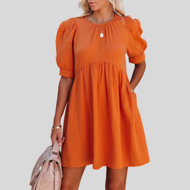 Lempi Celeste Moonshadow mini dress by Lumina Vancouver in vibrant orange, featuring a short, stylish design for a trendy look.