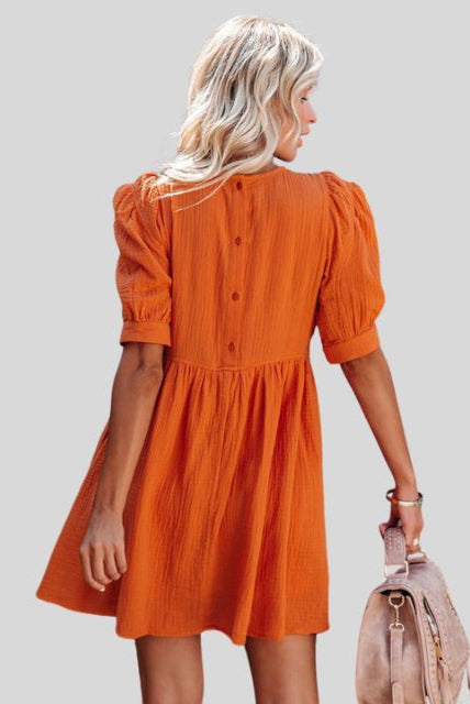 Lumina Wear Lempi Celeste Moonshadow mini dress in orange, featuring a short, stylish design with celestial-inspired pattern.