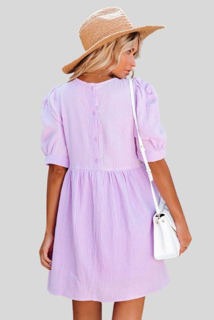 Lumina Wear Lempi Celeste Moonshadow mini dress in vibrant orange, featuring a short, stylish design perfect for summer occasions.
