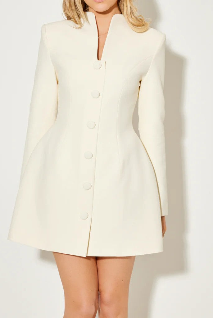 White Aurora coat dress with a statement bow collar by Lumina Vancouver, shown from the front on a model.