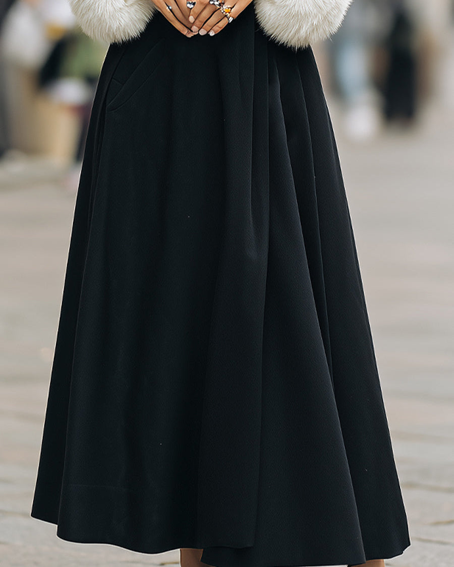 Black Lumina Wear Beryl longline coat with white faux fur trim, stylish outerwear for cold weather.