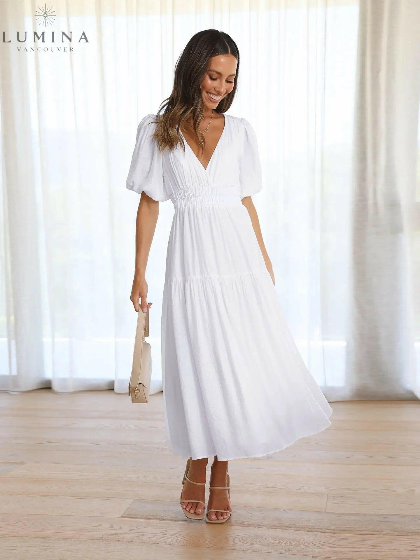Cream Avalon wedding guest dress by Lumina Wear with puff sleeves, shown on a model, perfect for elegant occasions.