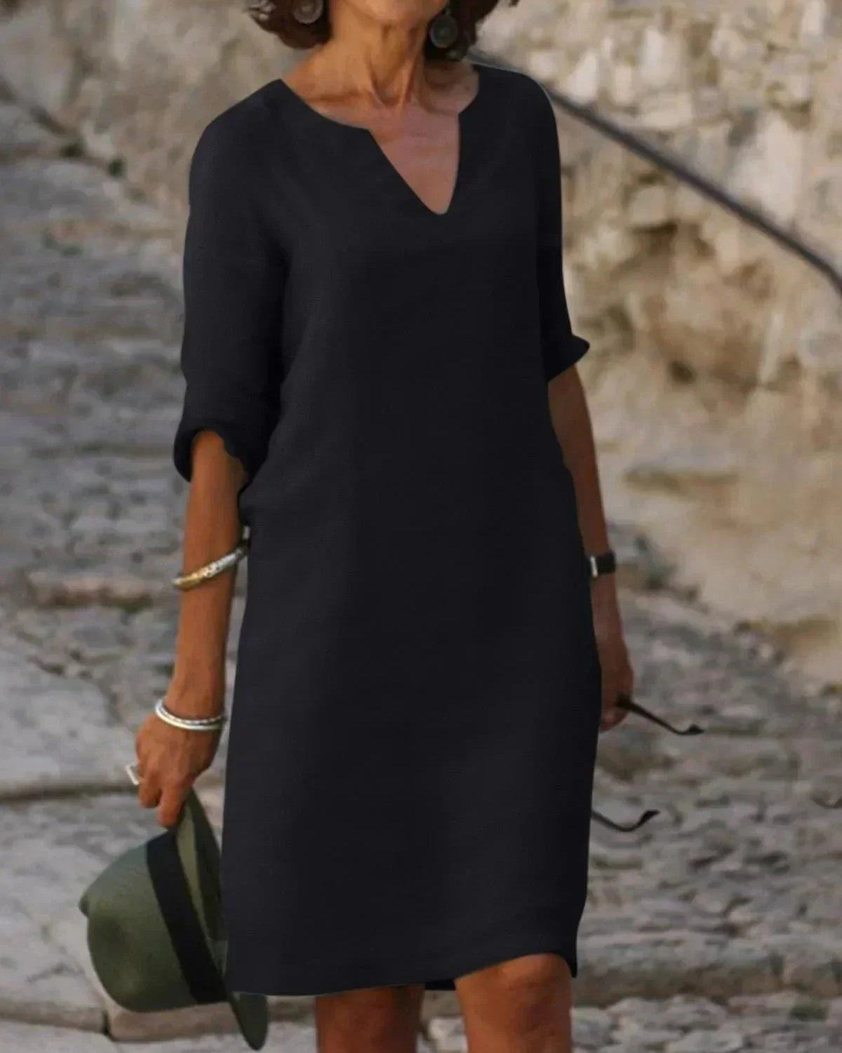 Black Beth Relaxed V-Neck Dress by Lumina Wear, casual fit with a soft fabric, displayed on a hanger.