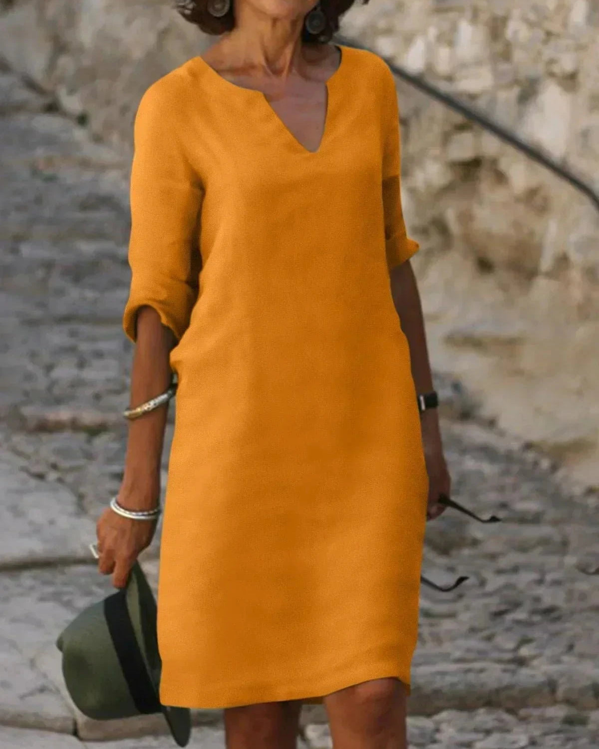 Black Beth relaxed V-neck dress by Lumina Wear, shown laid flat highlighting soft fabric and simple silhouette.