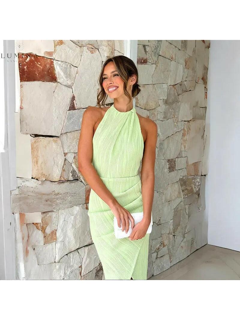 Green Brianna backless wedding guest dress by Lumina Vancouver, elegant sleeveless design with a fitted silhouette.