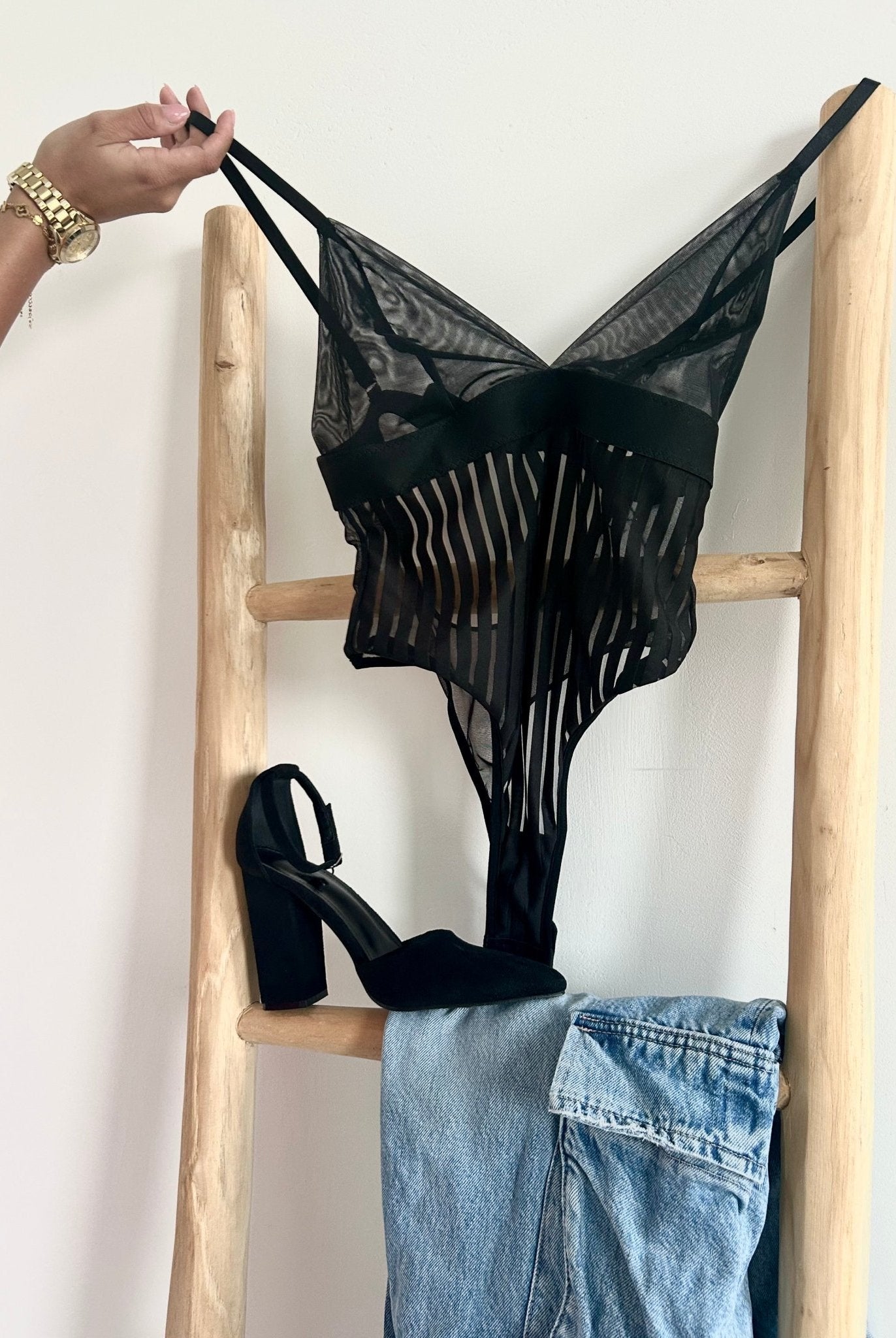 Lumina Wear Emmanuelle Bodysuit in sleek black, fitted design with long sleeves and high-cut style, displayed on a mannequin.