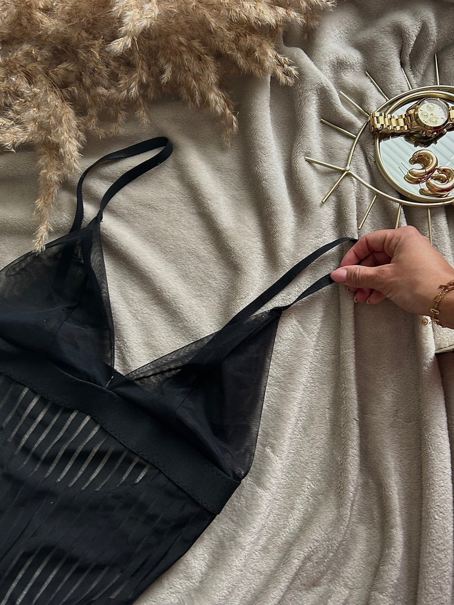Lumina Vancouver Emmanuelle Bodysuit shown in black, fitted design with long sleeves and scoop neckline, styled on a model.