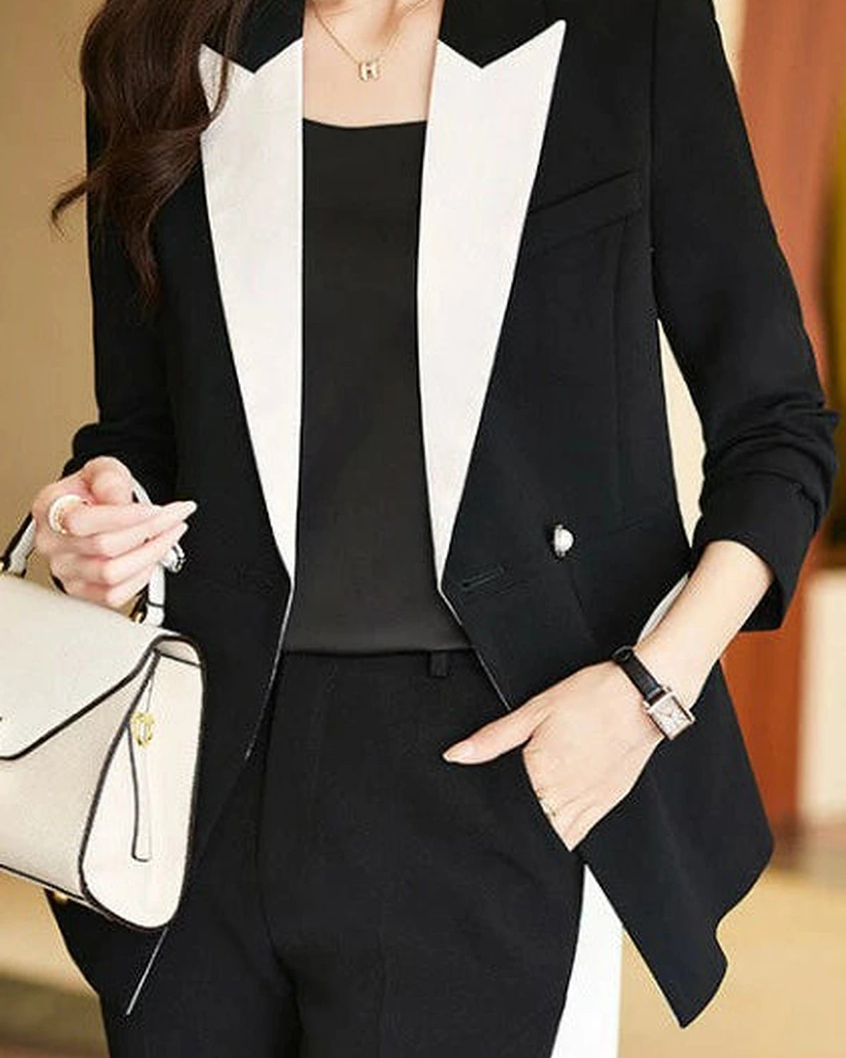 Black Camille monochrome tailored pant suit set by Lumina Wear, featuring a sleek, fitted design with structured blazer and matching pants.