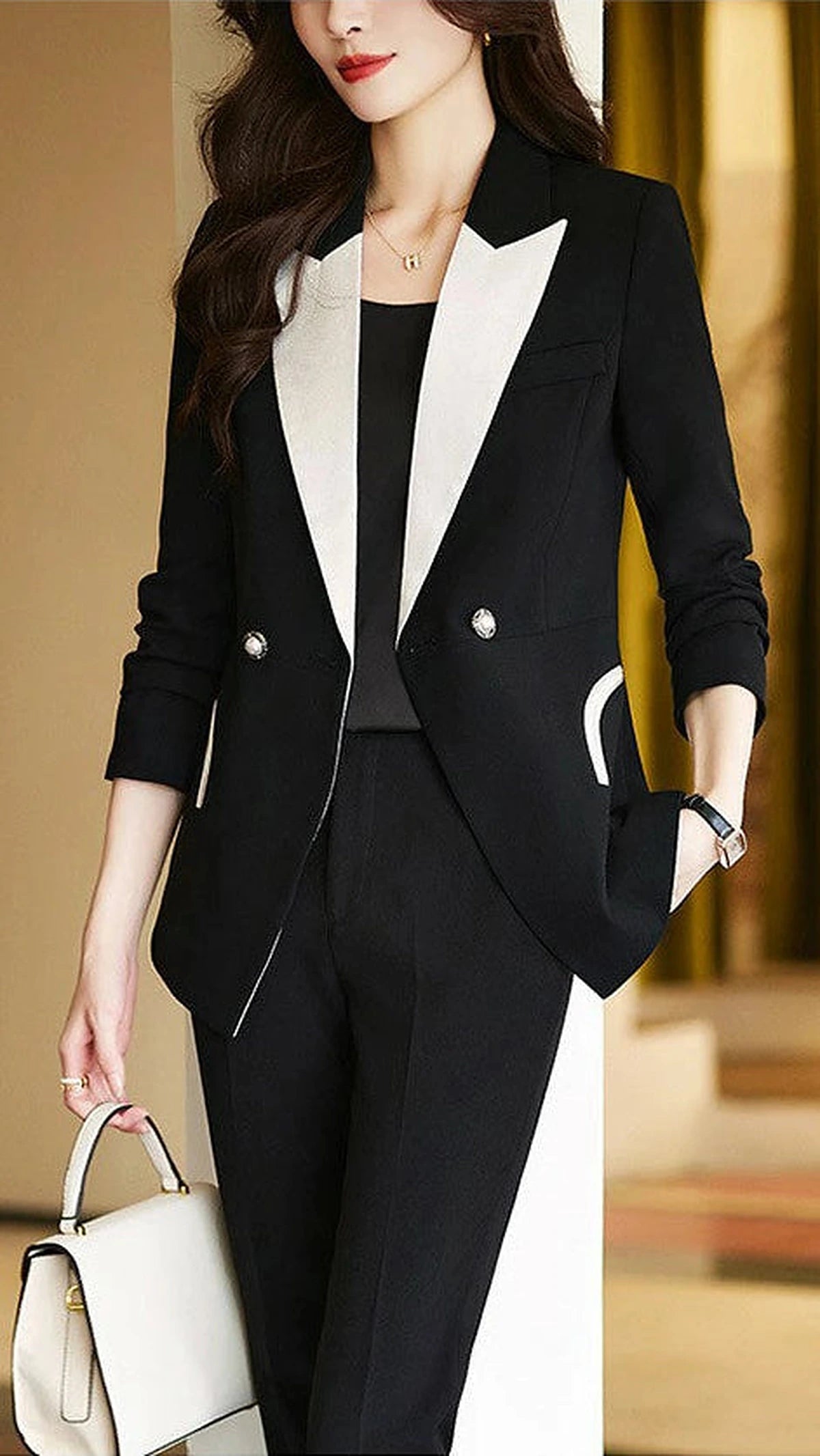 Black monochrome tailored pant suit set by Lumina Wear featuring a sleek, structured design for a sophisticated professional look.