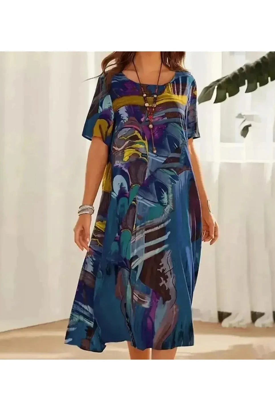 Elegant multi-color floral dress by Lumina Wear, featuring a flowing design and vibrant floral pattern in blue.
