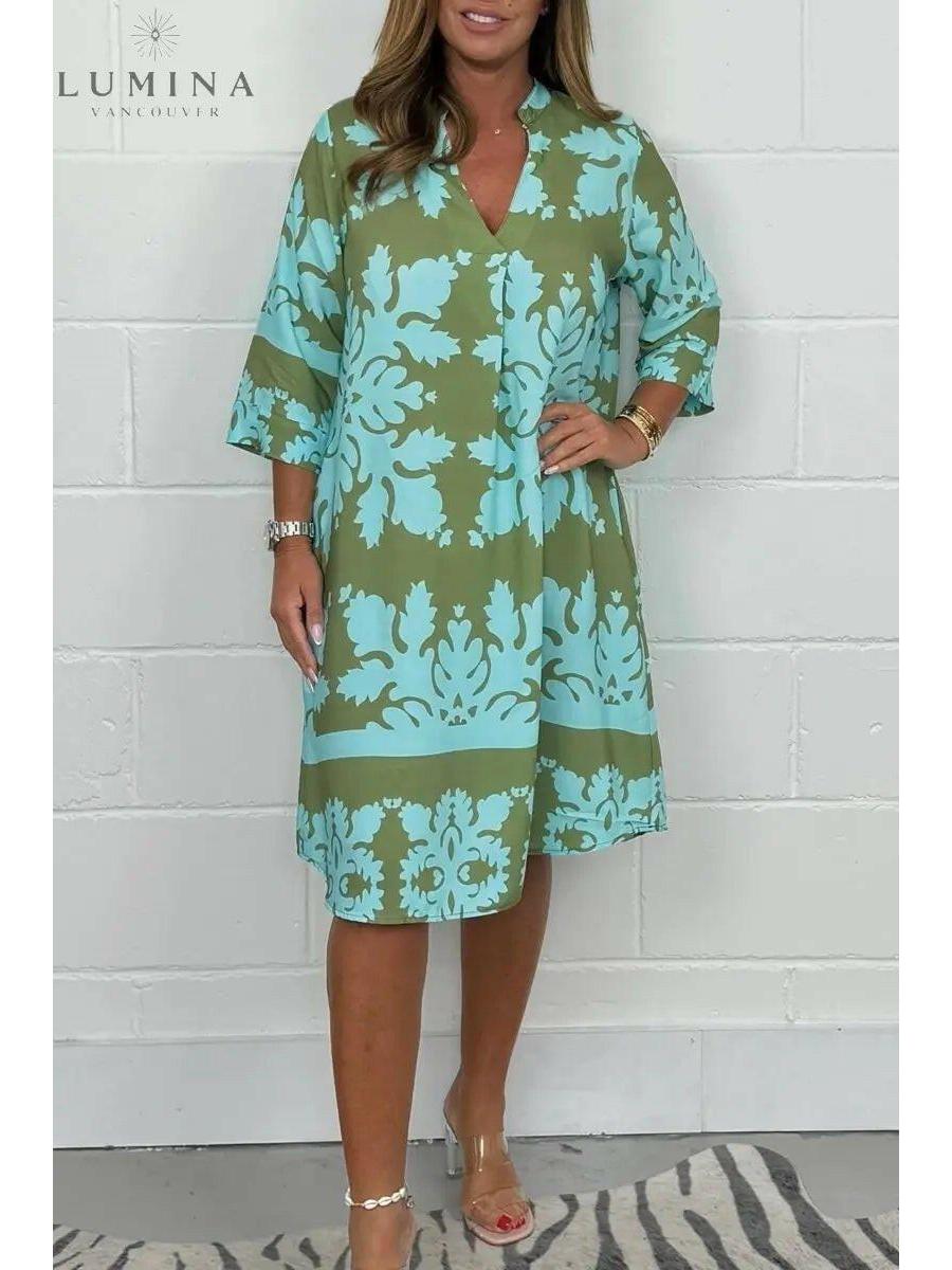 Blue and army green Bergljot spring dress by Lumina Vancouver, featuring a flowing design and floral pattern.