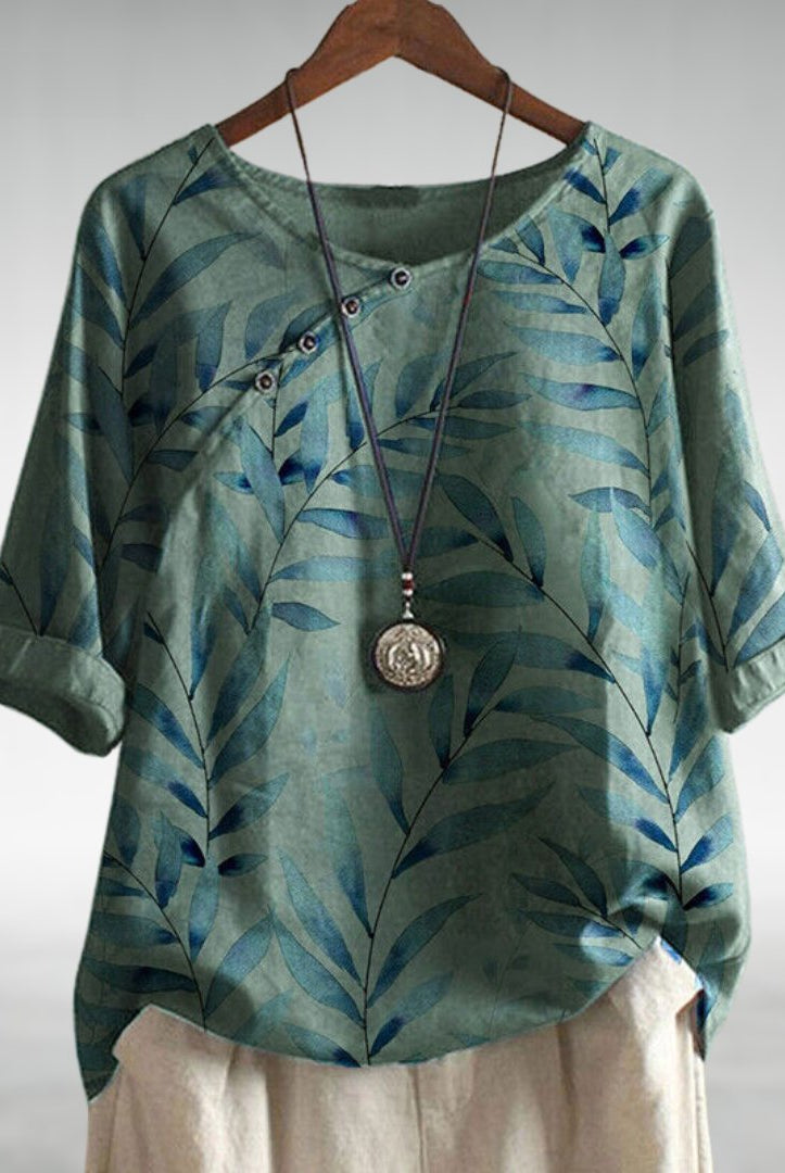 Blue Charlotte Breezy Leaf Print Blouse from Lumina Wear featuring button-up design and lightweight fabric.