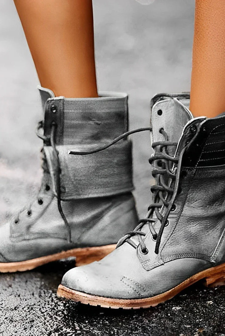 Black lace-up combat boots for women by Lumina Wear, rugged design with sturdy soles and metal eyelets.