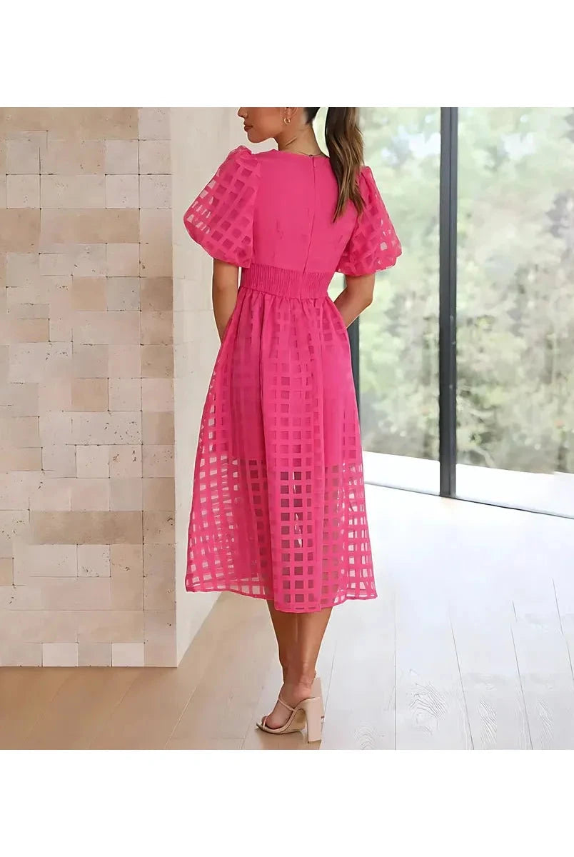 Pink Cindy midi dress by Lumina Vancouver with classic pattern and puff sleeves, perfect for elegant daytime or evening wear.
