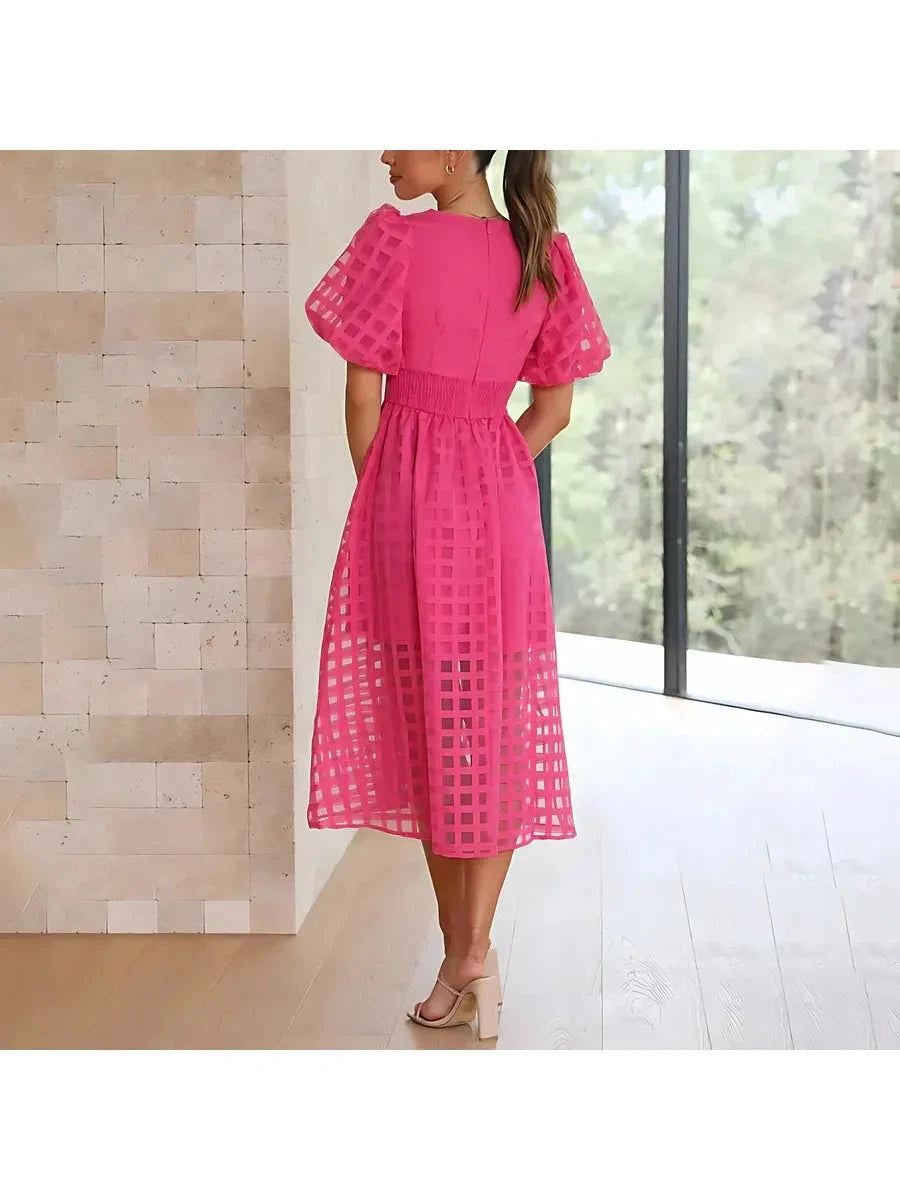 Pink Cindy midi dress by Lumina Vancouver with classic pattern and puff sleeves, perfect for elegant daytime or evening wear.