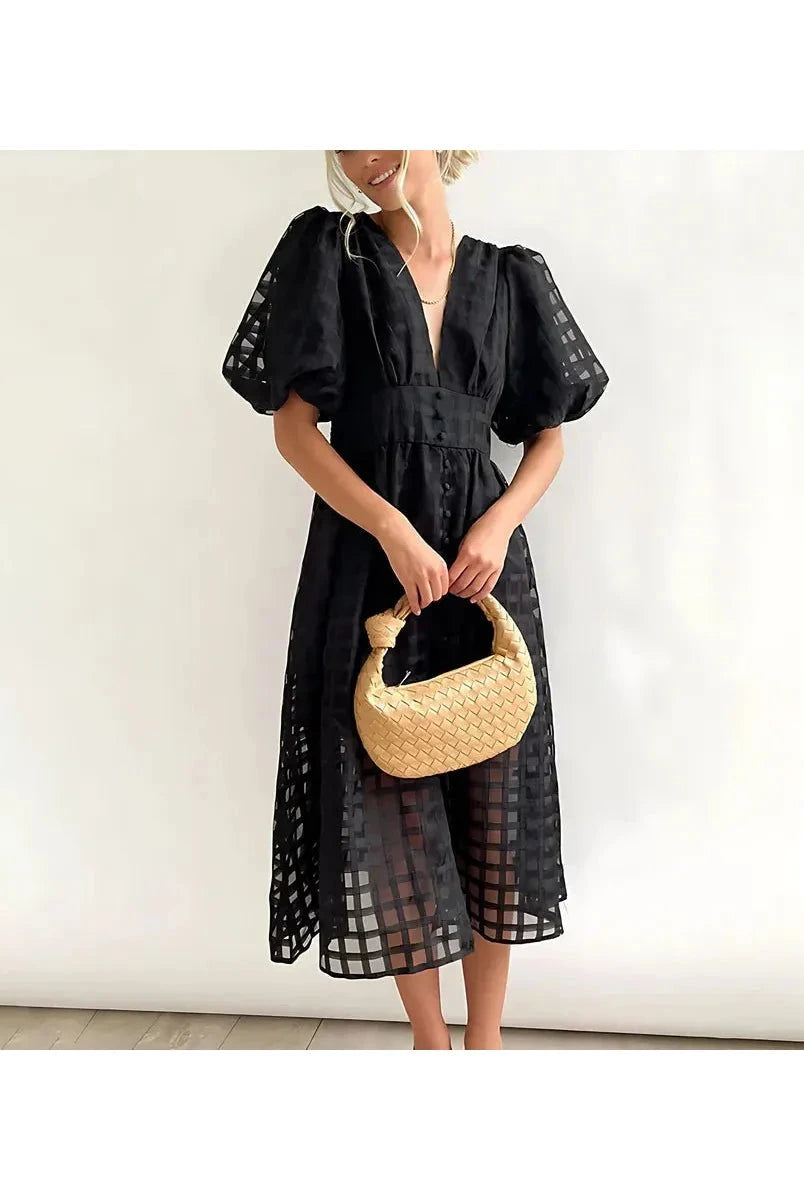 Pink Cindy midi dress by Lumina Vancouver featuring classic patterns and puff sleeves, displayed on a hanger.