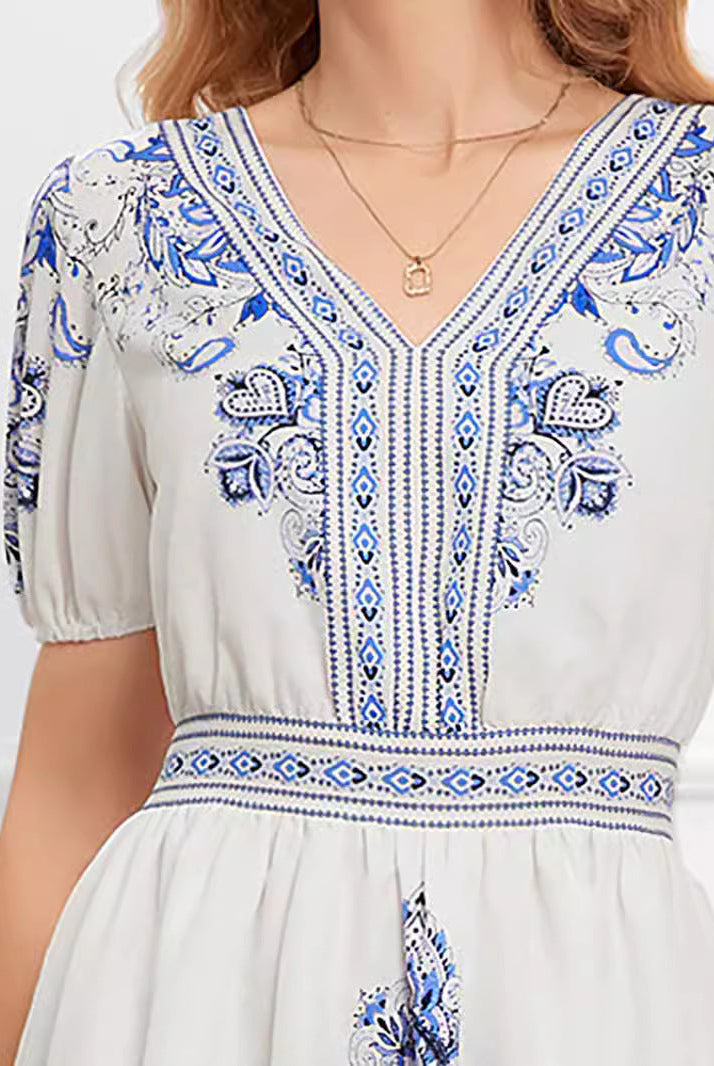 White printed cotton mini dress by Lumina Wear featuring a stylish, fitted silhouette and short sleeves.