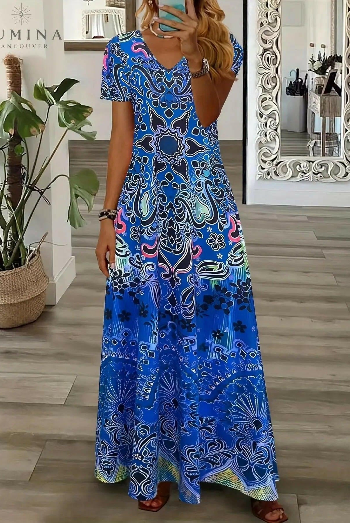 Red Daisy vintage V-neck dress by Lumina Vancouver, displayed on a hanger with floral pattern and retro-inspired design.