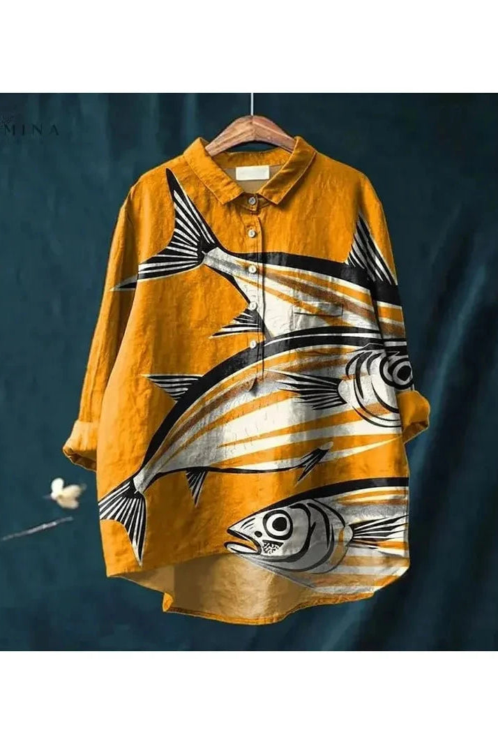 Light blue fish print T-shirt from Lumina Wear's Dana collection, featuring a detailed aquatic design on soft cotton fabric.
