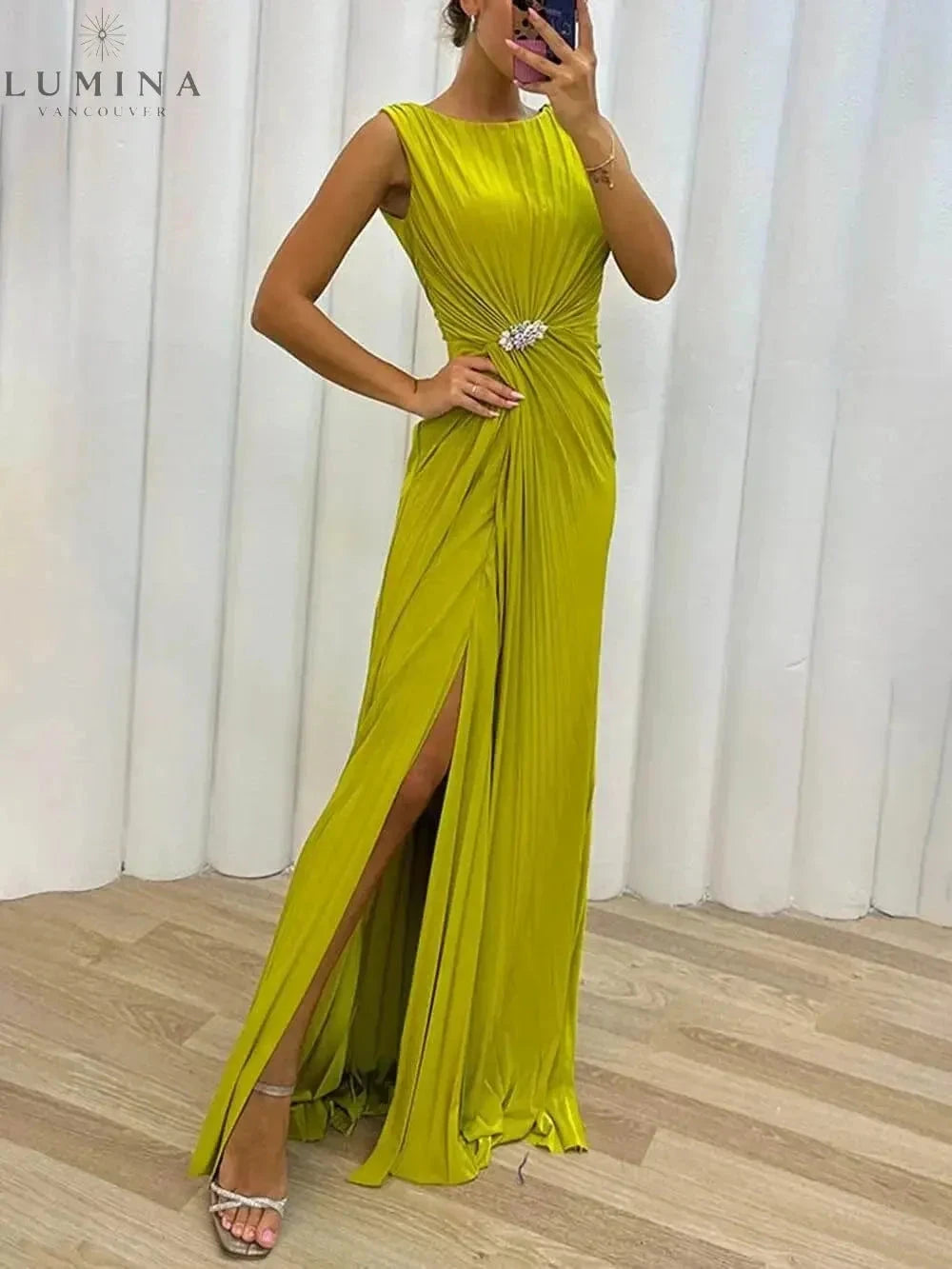 Yellow Davina pleated maxi evening dress by Lumina Vancouver, perfect for wedding guests, shown on a mannequin with flowing fabric.