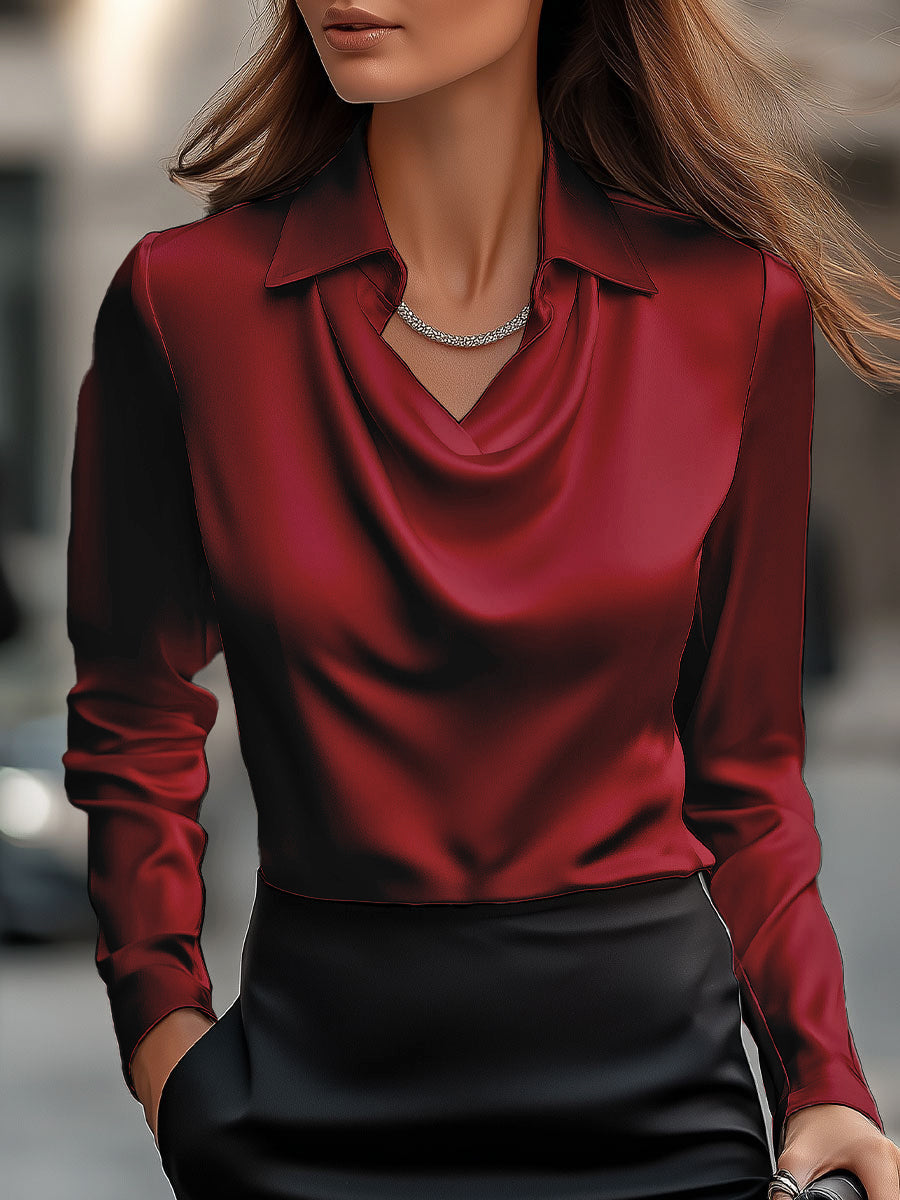 White Delphine satin blouse by Lumina Vancouver, featuring elegant draped design and long sleeves, shown on a model.