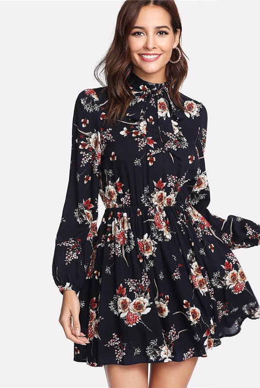 Wenche Bloom Meadow floral mini dress by Lumina Wear featuring dark blue fabric, floral pattern, short sleeves, and fitted silhouette.