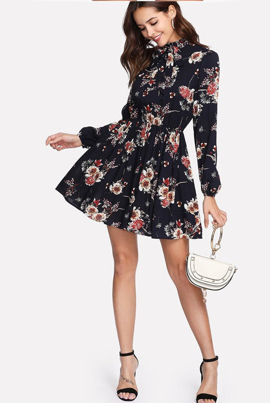 Dark blue Wenche Bloom Meadow floral mini dress by Lumina Wear, featuring a feminine floral pattern and lightweight fabric.