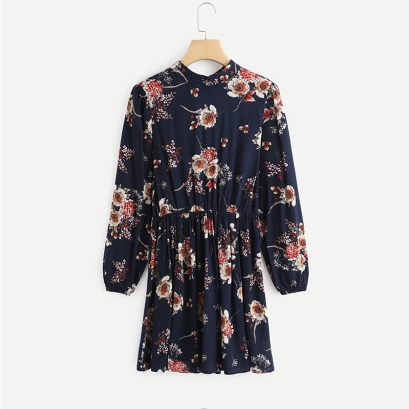Wenche Bloom Meadow floral mini dress by Lumina Vancouver, dark blue fabric with a fitted silhouette and floral pattern.