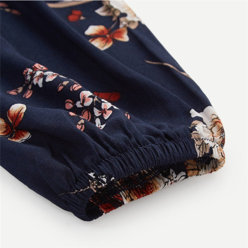 Dark blue Wenche Bloom Meadow floral mini dress by Lumina Vancouver, featuring a feminine floral pattern and stylish fit.