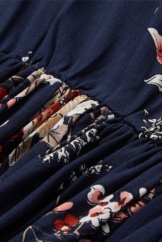 Dark blue Wenche Bloom Meadow floral mini dress by Lumina Wear, featuring a feminine design with a floral pattern.