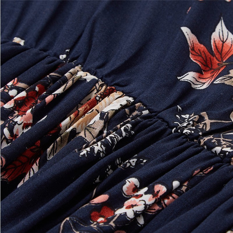 Dark blue Wenche Bloom Meadow floral mini dress by Lumina Vancouver, featuring a fitted bodice and flowing skirt with floral pattern.