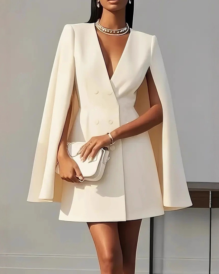 Lumina Wear Elara double-breasted cape mini dress in apricot, featuring a stylish design and tailored fit.